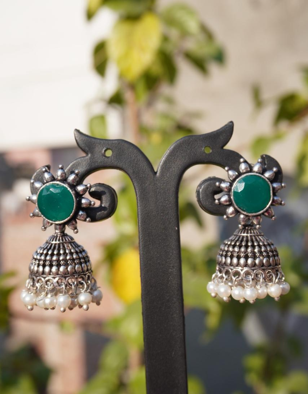 Antique Silver-Finished Jhumka Earrings with Emerald Green Stone and Pearl Accents