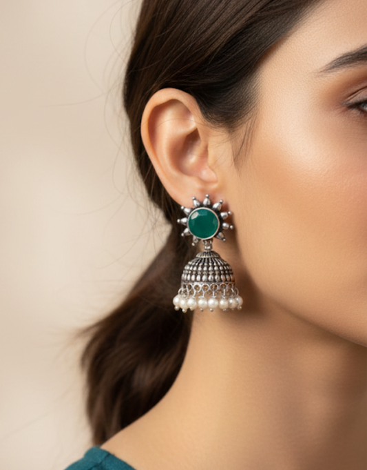 Antique Silver-Finished Jhumka Earrings with Emerald Green Stone and Pearl Accents
